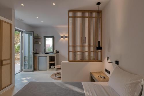 a bedroom with a bed and a desk in a room at Clementina Paros in Naousa