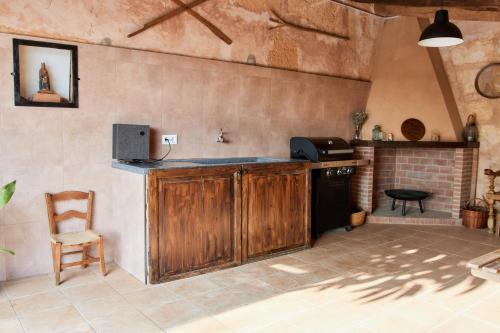 a kitchen with a counter and a chair in a room at Ses cases noves Llucmajor in Llucmajor