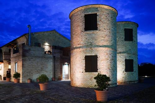 un grande edificio in mattoni con due torri di Moretti Village - B&B a Civitanova Marche