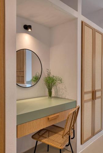 a dressing room with a mirror and a chair at Clementina Paros in Naousa