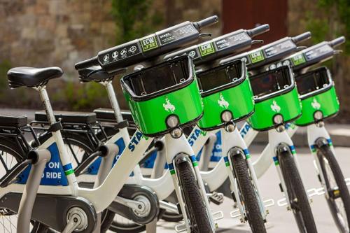 a row of bikes with green baskets on them at Wyoming Inn of Jackson Hole in Jackson