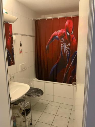 a bathroom with a spider man shower curtain at Lion BB Swiss in Zurich