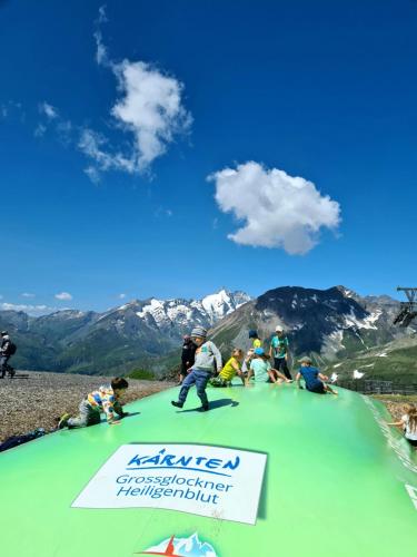 a group of people sitting on top of a mountain at Superior Apartment Eva in Heiligenblut