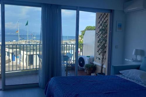 a bedroom with a bed and a view of the ocean at 06AT1 - Studio cosy bord de mer situation idéale in Antibes