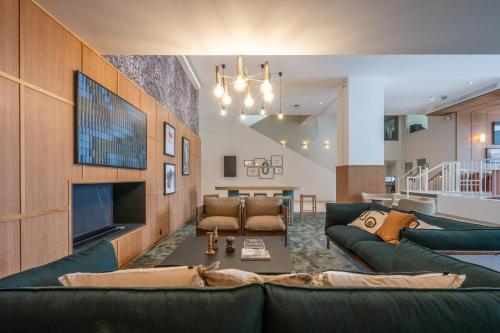 a living room with a couch and a fireplace at Mercure La Rochelle Vieux Port in La Rochelle