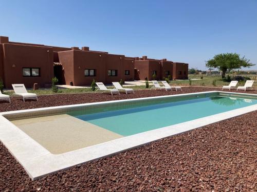 a swimming pool in front of a building at La Cobija Apartamentos - Solo Adultos in Ciudad Real