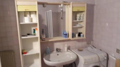 a small bathroom with a sink and a toilet at Lorenzo's House in Thiene