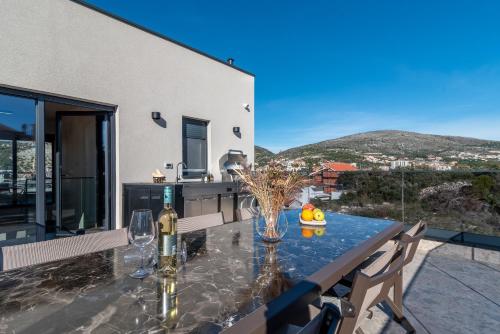 a dining room with a table with a view at Villa Mia- Private Wellness & Spa in Seget Vranjica