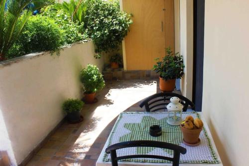 a table and chairs on a patio with plants at A&B My Sweet Home 1 in Ioannina