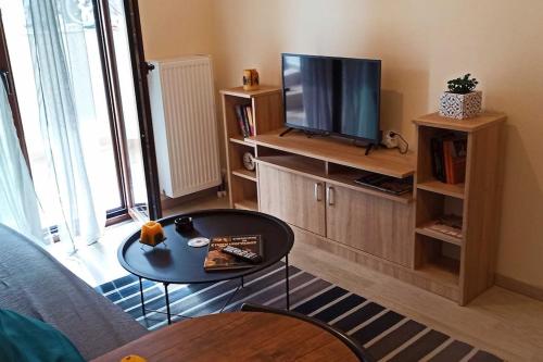 a living room with a table and a television at A&B My Sweet Home 1 in Ioannina