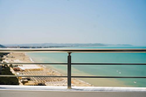 a view of the beach from the balcony of a building at Beachfront Marilyn in Durrës