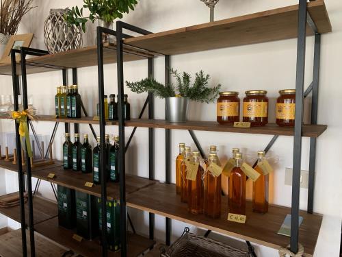 a shelf filled with bottles of alcohol on a wall at Agriturismo La Terrazza su Farfa in Castelnuovo di Farfa