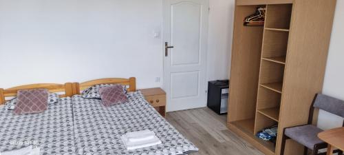 a bedroom with a bed and a book shelf at UniBal - pokoje gościnne in Unieście