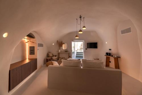 a bedroom with a bed and a living room at Twenty One Suites in Oia