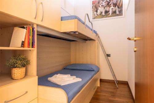 a small room with a bunk bed and stairs at IseoLakeRental - La Magia del Lago in Ranzanico