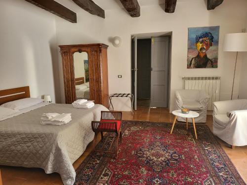 a bedroom with a bed and a living room at b&b Vallone del grano in Rossano