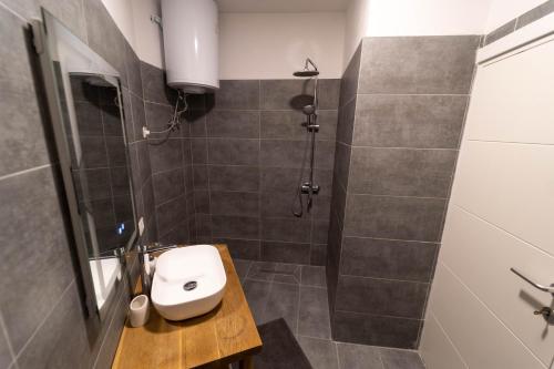 a bathroom with a shower with a toilet and a sink at Beachfront Marilyn in Durrës