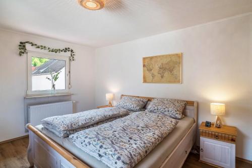 a bedroom with a bed and a window at Pfälzerwald Idyll in Schwanheim