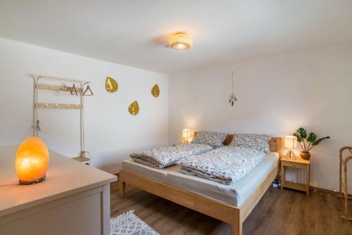 a bedroom with a bed and a table at Pfälzerwald Idyll in Schwanheim