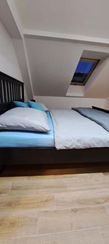 a bedroom with a large bed with a window at Pension ANDREA in Mikulov