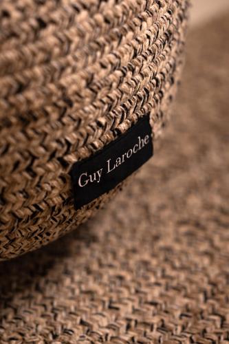 a close up of a city language tag on a brown rug at Twenty One Suites in Oia