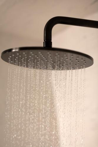 a shower head with water dripping from it at Twenty One Suites in Oia