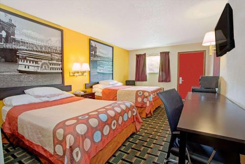 a hotel room with two beds and a desk at Super 8 by Wyndham Cincinnati-Springdale OH in Springdale