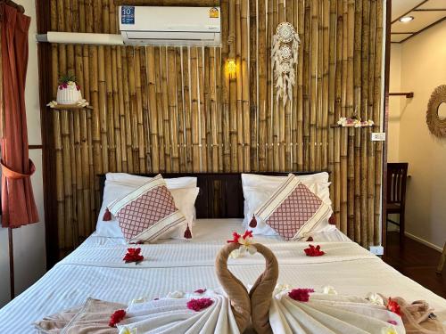 a bedroom with two swans on a bed at Bangrak Pier Bungalow in Bang Rak Beach