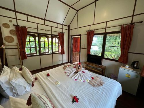 a room with a bed with a doll on it at Bangrak Pier Bungalow in Bang Rak Beach