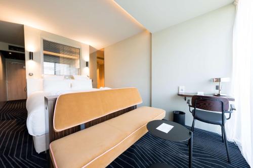 a hotel room with a bed and a desk at Best Western Plus Clos Syrah in Valence
