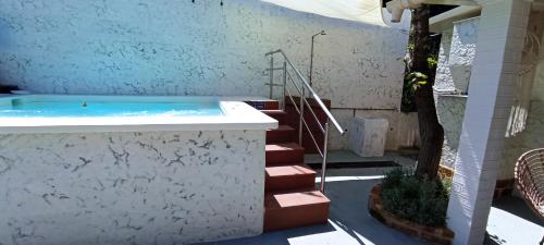 a jacuzzi tub in a building with a tree at Wooden Summer House in Mantoúkion
