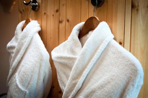 two white towels are hanging on a wall at Best Western Plus Hôtel Vannes Centre Ville in Vannes