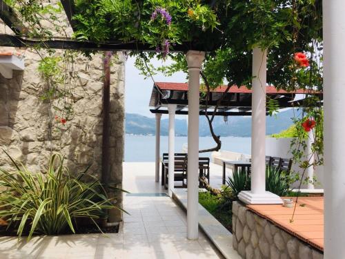 a patio with a table and a view of the water at La casa di Sonja in Tivat