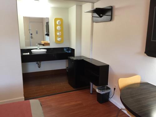 a bathroom with a sink and a mirror at Motel 6-Glassboro, NJ - Rowan University in Glassboro