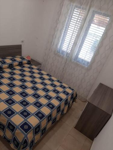 a bedroom with a bed and two windows at Casa vacanze Gemini in Triscina
