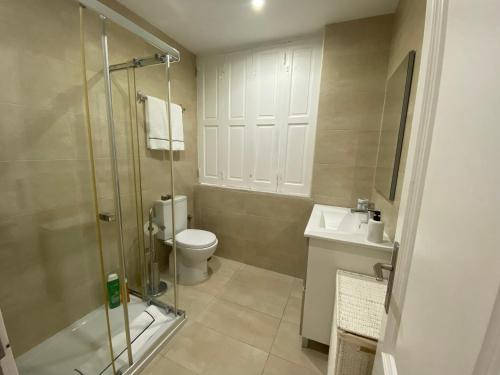 a bathroom with a shower and a toilet and a sink at Estoril Casino 3 Bedrooms With Pool in Estoril