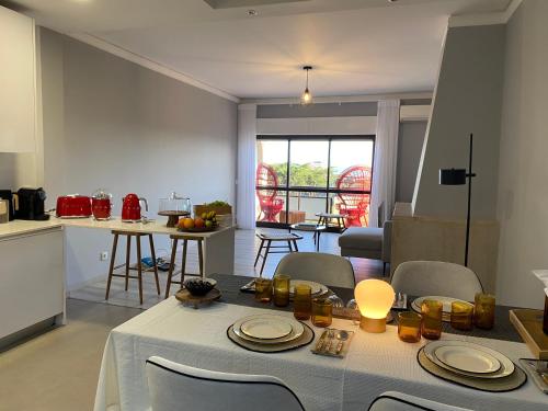 a kitchen and living room with a table and chairs at Estoril Casino 3 Bedrooms With Pool in Estoril