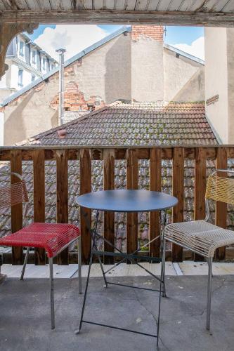 two chairs and a table on a patio at Résidence Aristide Briand - Appartements en Centre Ville in Vichy