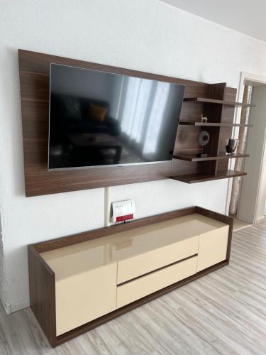 a flat screen tv on a wall in a living room at Apartment Künzelsau in Künzelsau