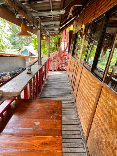 a train platform with a wooden floor and windows at Good Life Dacha Wellness Homestay in Pai