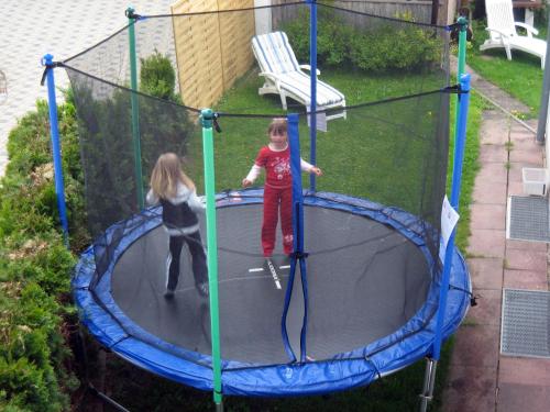 two young children playing on a trampoline at Ferienwohnungen Stark in Kelheim