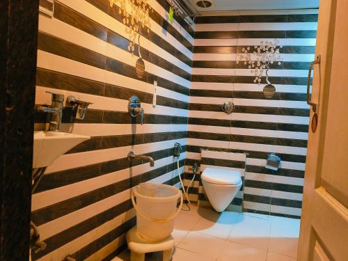 a bathroom with a toilet and a sink at Apex Hotel in Mumbai