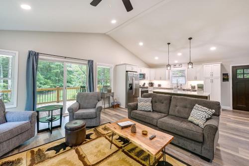 a living room with two couches and a table at Creekside Cabin in Franklin about 8 Mi to Downtown! in Franklin