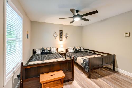 a bedroom with two beds and a ceiling fan at Creekside Cabin in Franklin about 8 Mi to Downtown! in Franklin