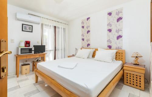 a bedroom with a large bed and a tv at Rudel Room with Terrace in Fažana