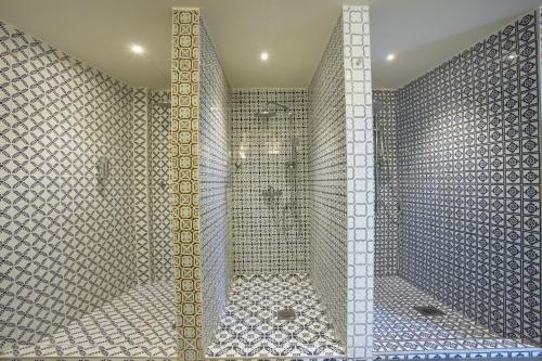 a bathroom with a shower with a mirror at Bushi Resort & SPA in Skopje