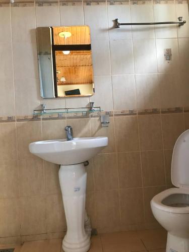 a bathroom with a sink and a toilet at Legenda Health Resort in Kaji-Say