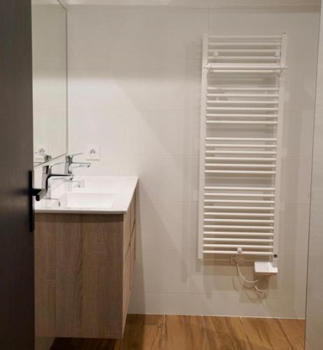 a bathroom with a sink and a mirror at Gîte de l’Ambiance in Francheville