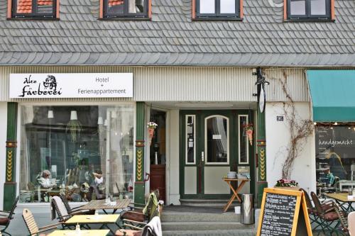 a restaurant with tables and chairs in front of a building at Hotel Alte Färberei in Goslar