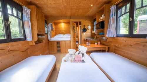 a room with two beds and two teddy bears at Le Village de la Champagne - Slowmoov in Bar-sur-Aube